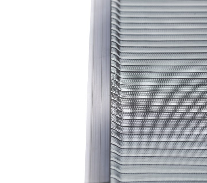 Close-up of the edge of a metallic or aluminum air filter with a mesh pattern and thin horizontal ridges, set against a white background. The filter is positioned vertically with visible frame detail.